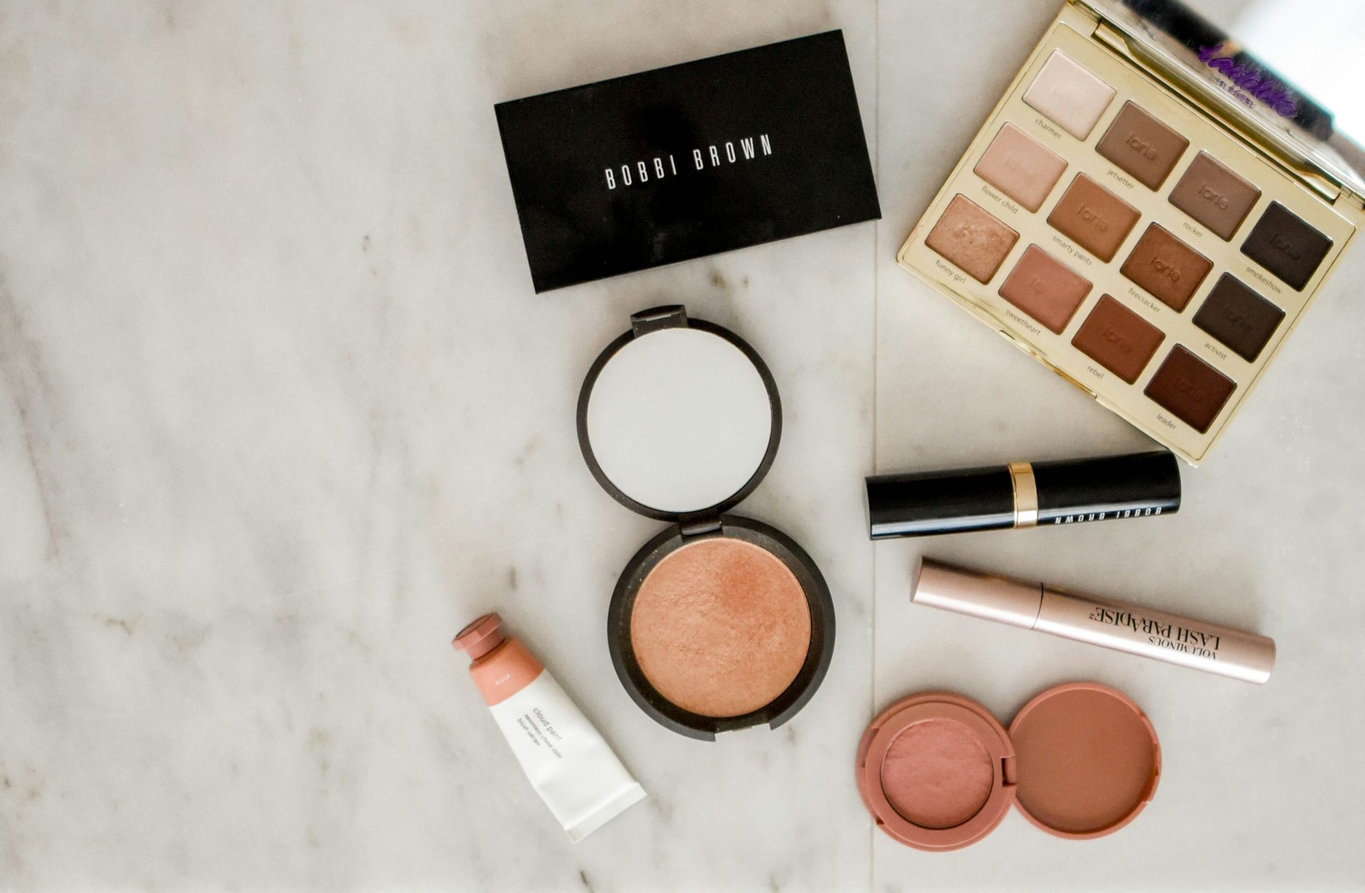 Assorted makeup palettes and tools on counter