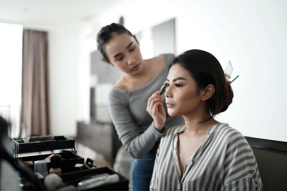 Makeup artist applying eyeshadow with precision